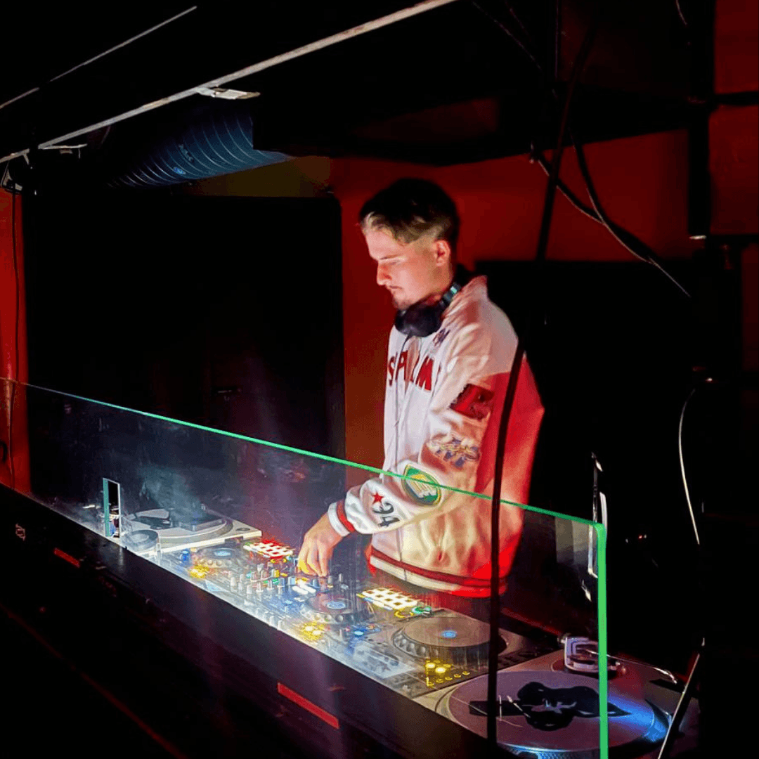 James Deans performing behind a DJ booth